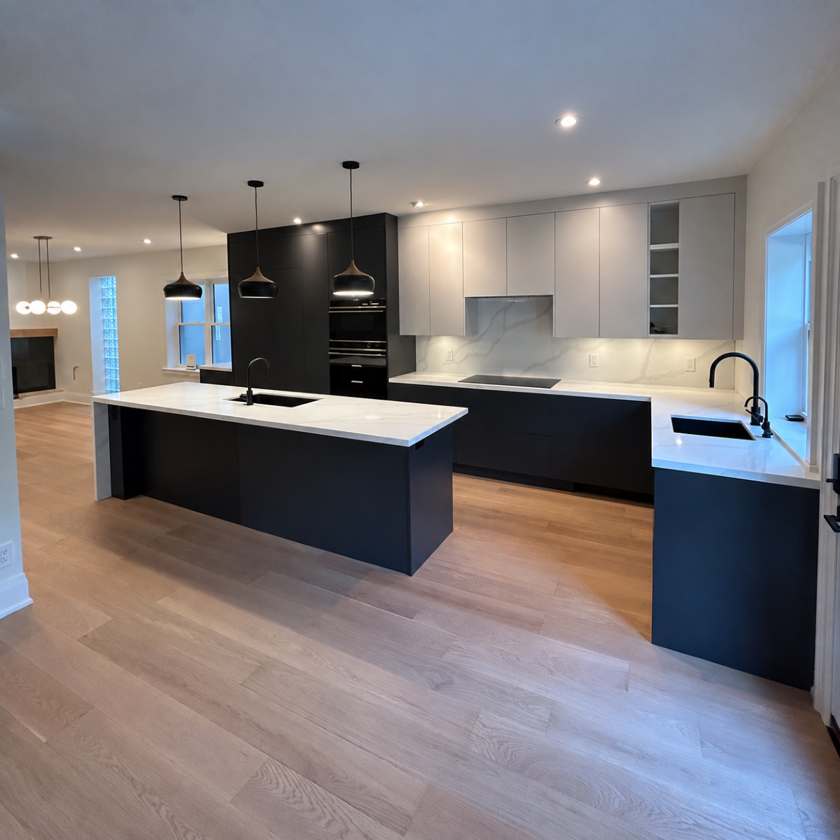 Contemporary kitchen with dark island by AMA Renovations